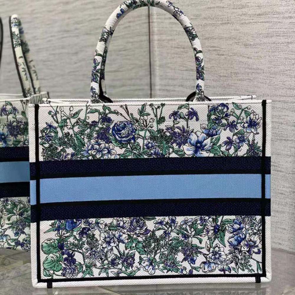 Side angle showing silver hardware and blue canvas on Dior tote