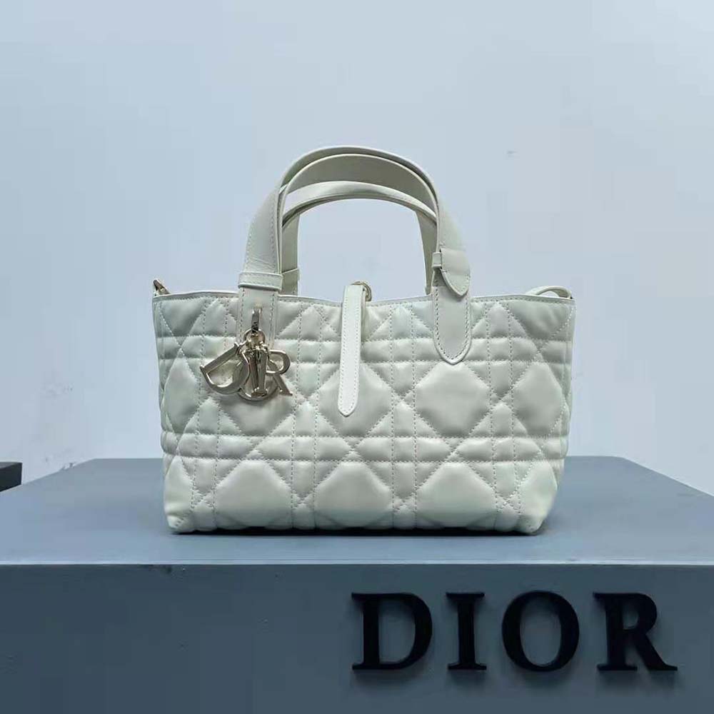 Side profile showing compact silhouette of Dior Women Small Dior Toujours Bag in white