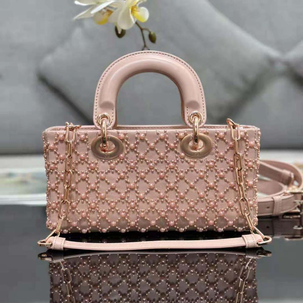 Side angle highlighting silver hardware and flap closure of Lady D-joy Bag