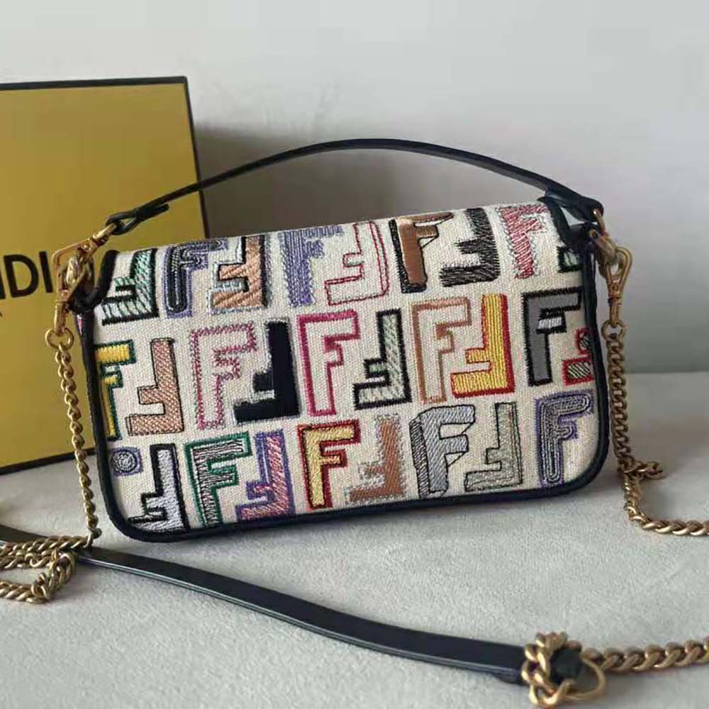 Side angle showing silhouette and flap closure of Fendi Women Baguette Mini bag