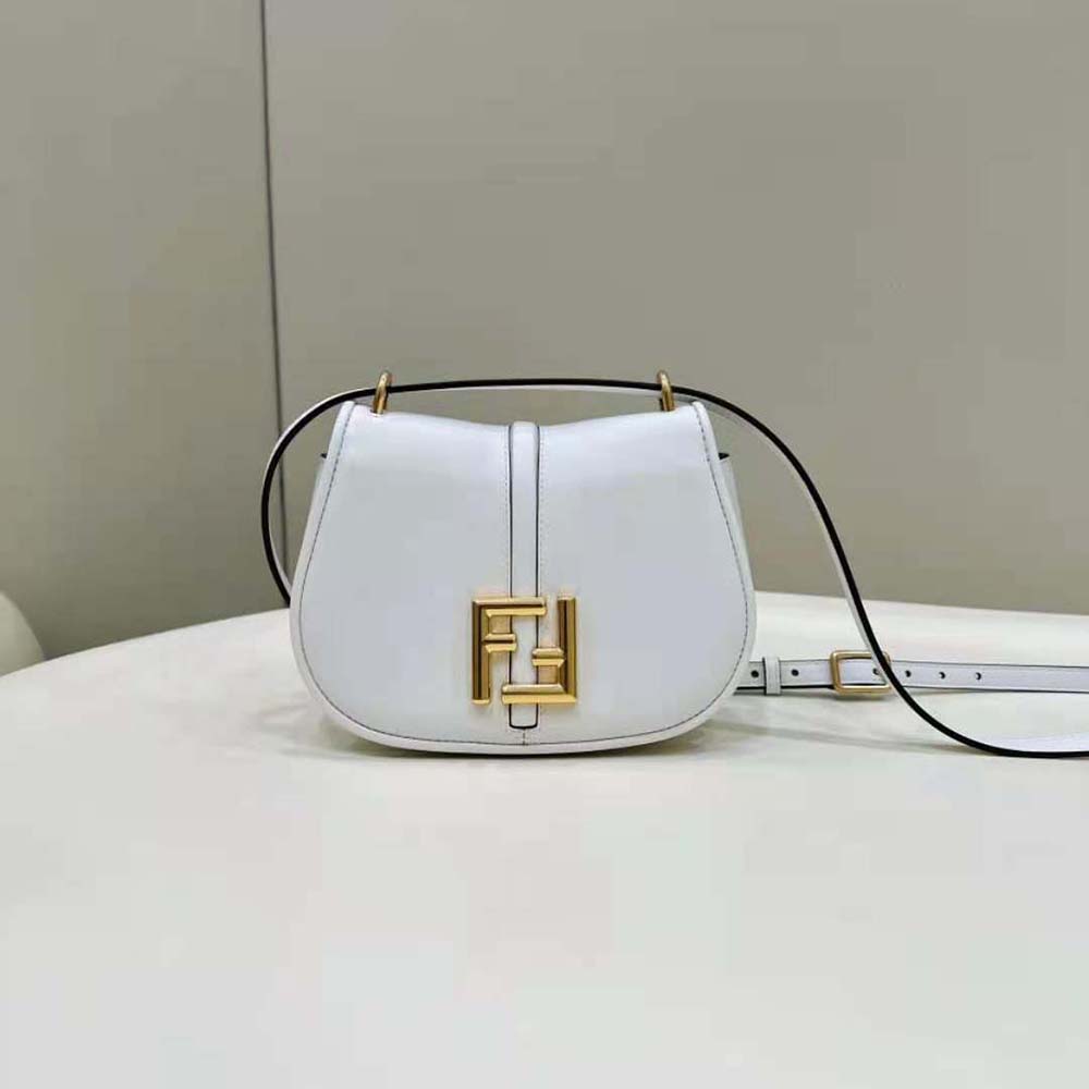 Close-up on signature gold-tone metal logo closure of Fendi Women C’mon Mini White Leather Bag