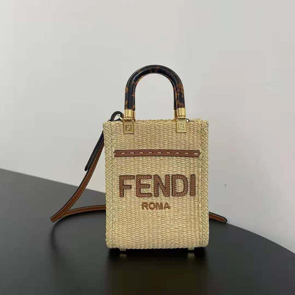 Close-up of gold hardware and beige straw texture on Fendi mini-bag