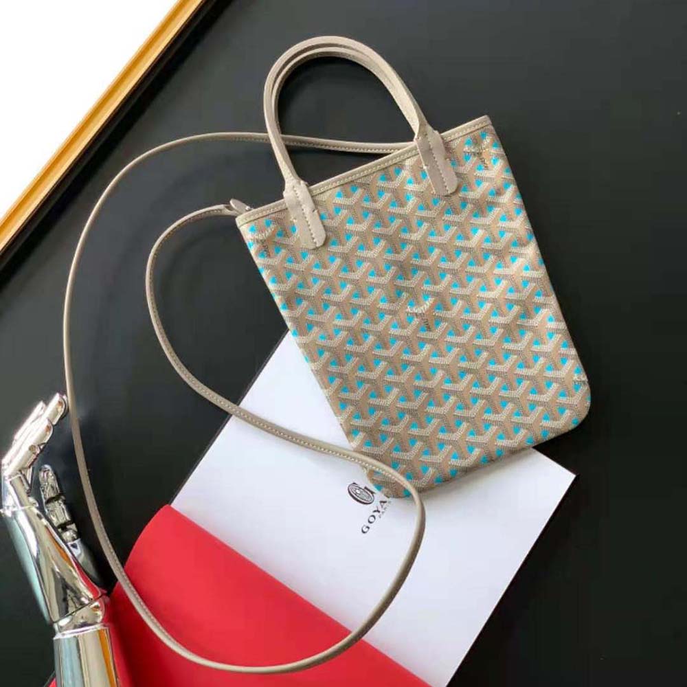 Close-up detail of blue canvas and gold hardware on Goyard Poitiers Claire-voie Bag