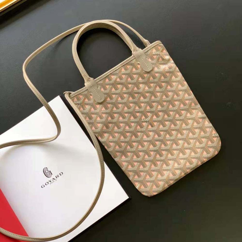Close-up of pink coated canvas and gold hardware on Goyard bag