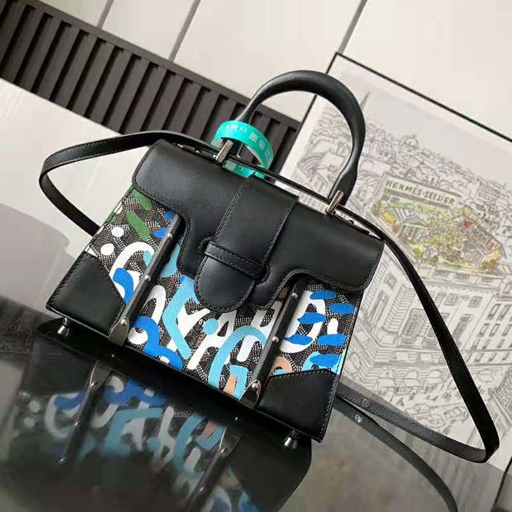 Close-up on silver hardware and blue camouflage pattern, Goyard mini bag