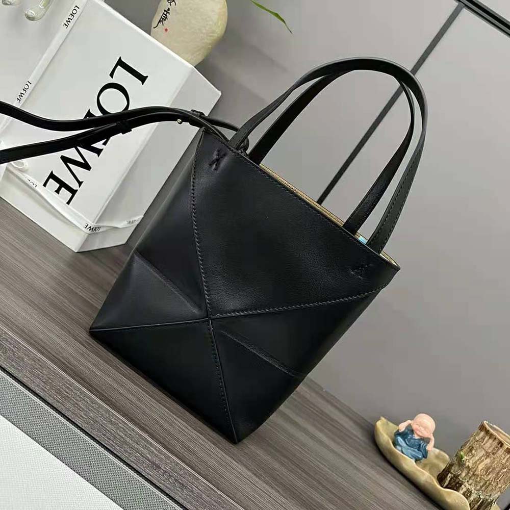 Side profile showing folded silhouette and top zip of Loewe Unisex Mini Puzzle Fold Tote