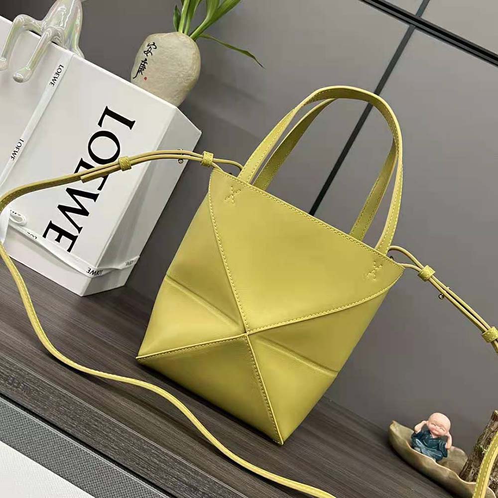 Side view showing compact fold design of Loewe Unisex Mini Puzzle Fold Tote