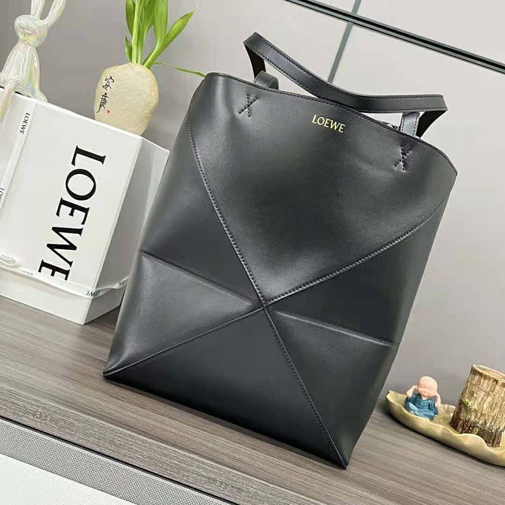 Close-up of silver-tone hardware on Loewe Puzzle Fold Tote black leather