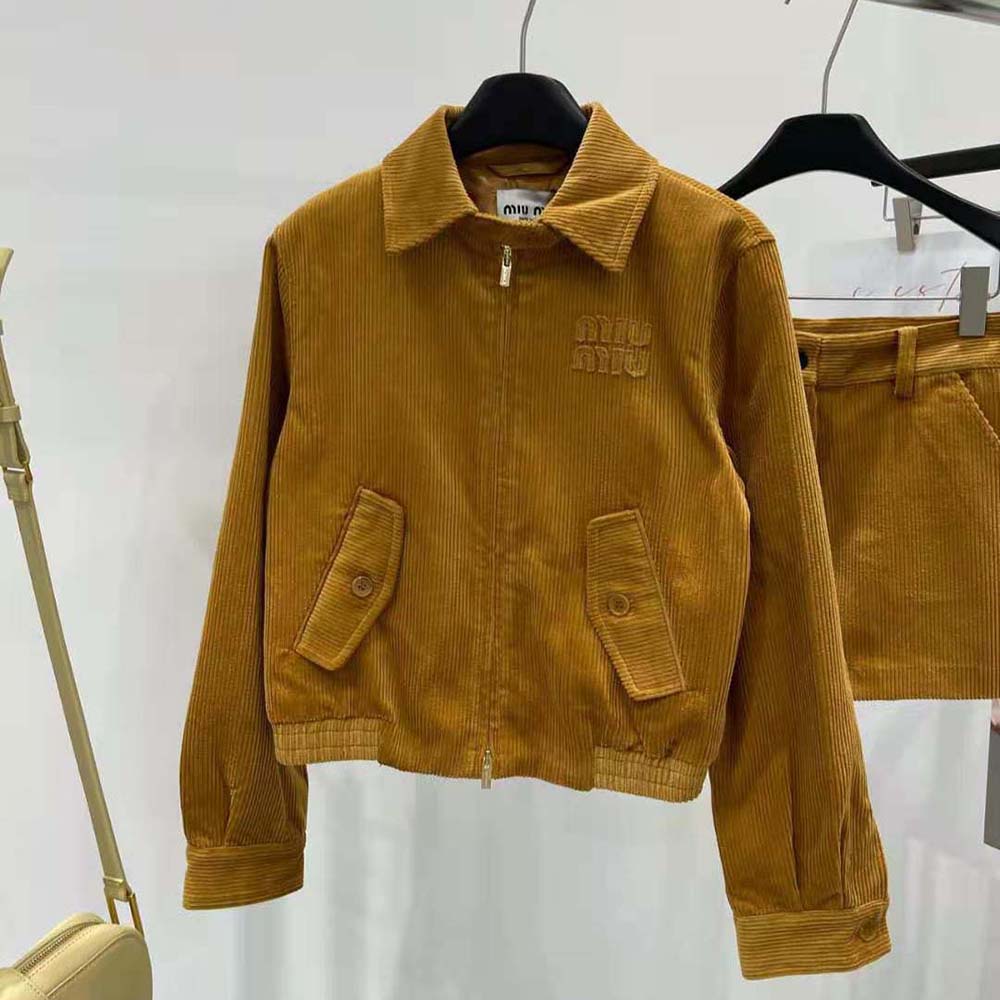 Close-up of corduroy texture and embossed zipper on Miu Miu jacket