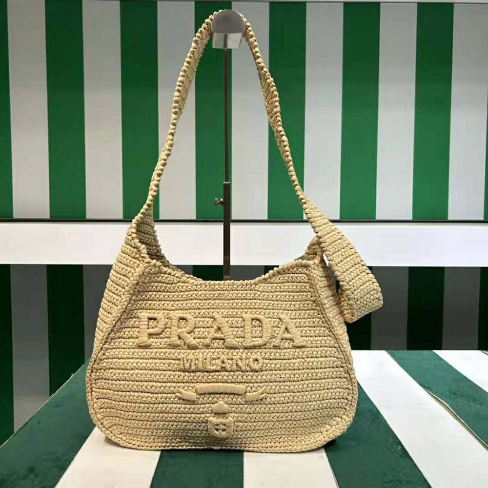 Close-up of embroidered Prada logo on crochet tote bag natural color