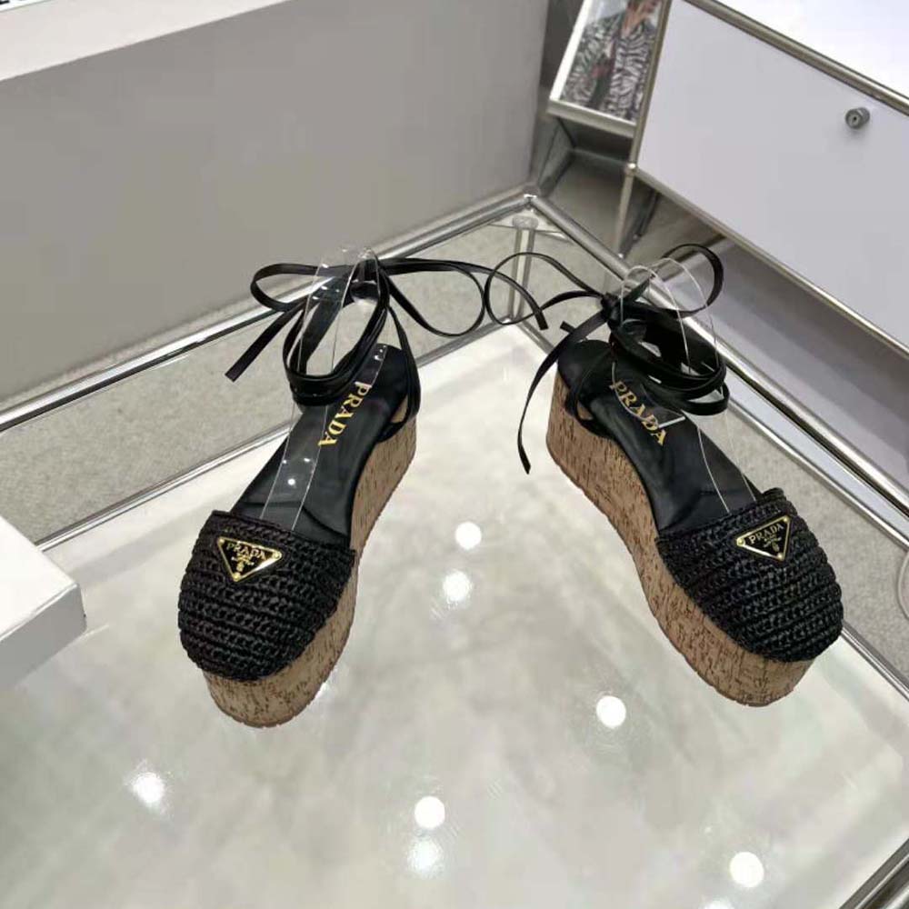Close-up on enameled metal triangle logo on Prada Women Crochet Wedge Sandals