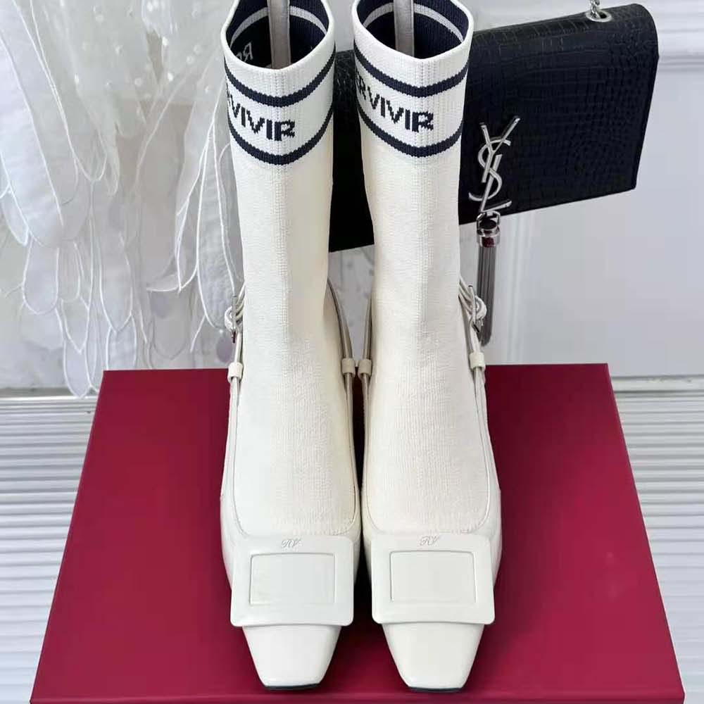 Close-up on lacquered buckle detail of Roger Vivier White Patent Leather ankle boots
