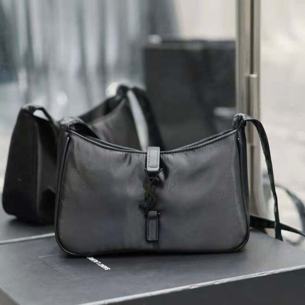 Close-up on silver YSL logo hardware of the Saint Laurent YSL crossbody bag