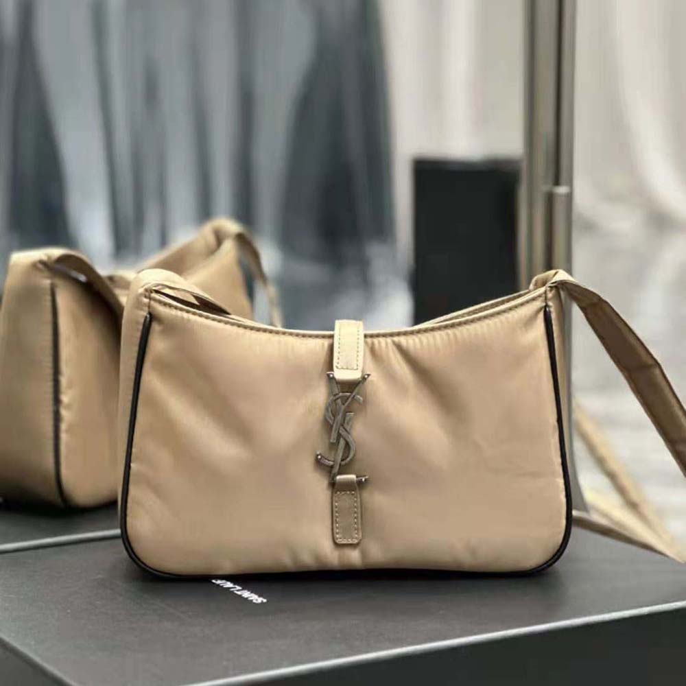Close-up of silver YSL hardware on brown Econyl® nylon bag