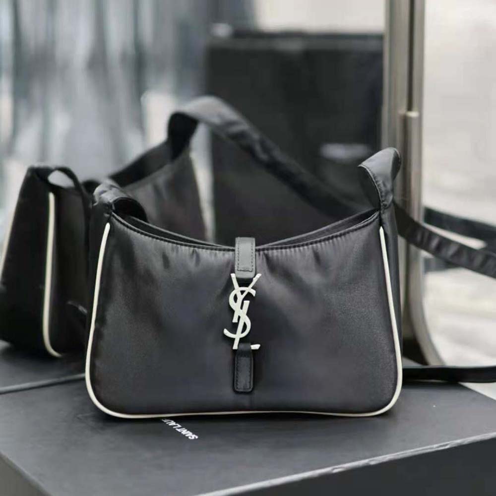 Close-up of silver YSL hardware on white Econyl® crossbody bag