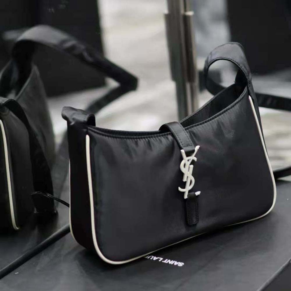 Side profile showing zip closure on Saint Laurent YSL white crossbody bag