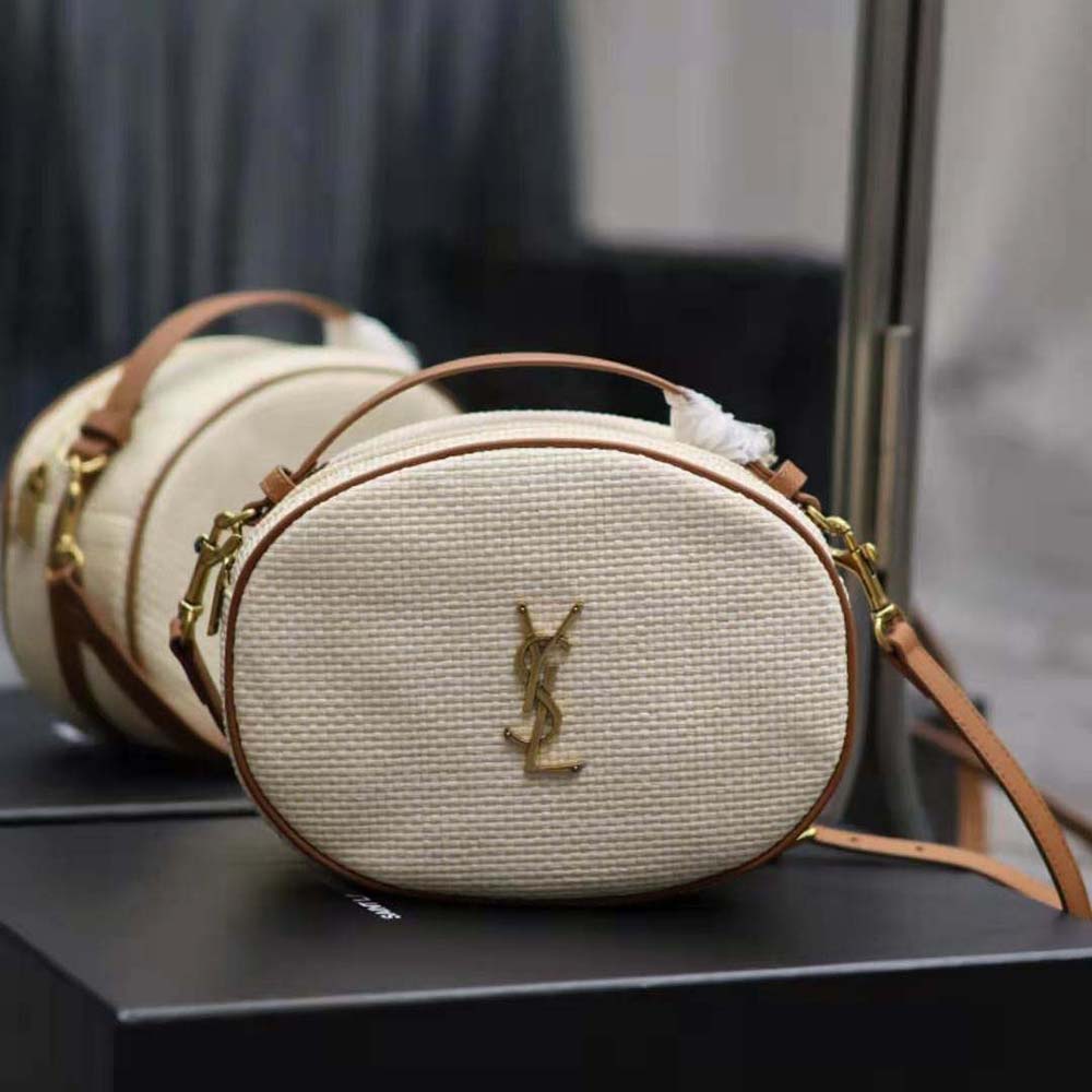 Close-up on gold YSL hardware and zip closure of the camera bag