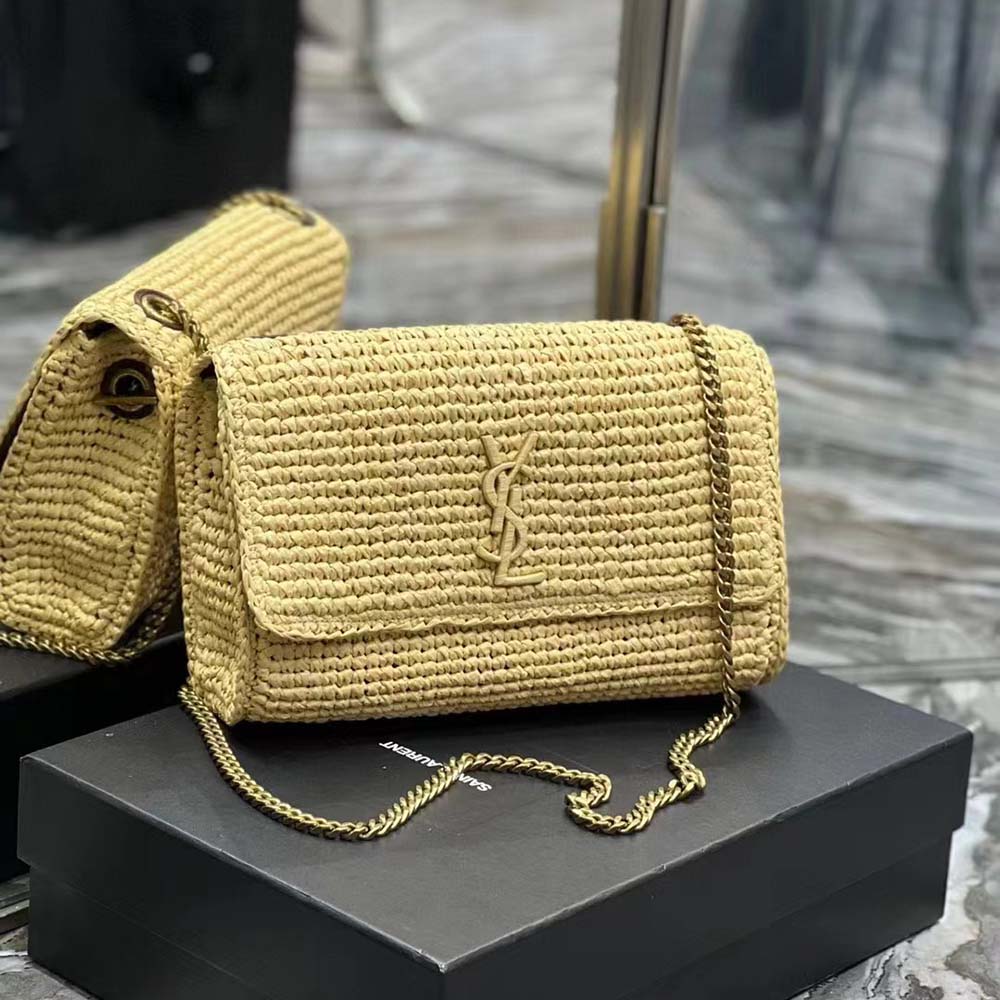 Close-up detail of gold-tone YSL chain hardware on raffia bag