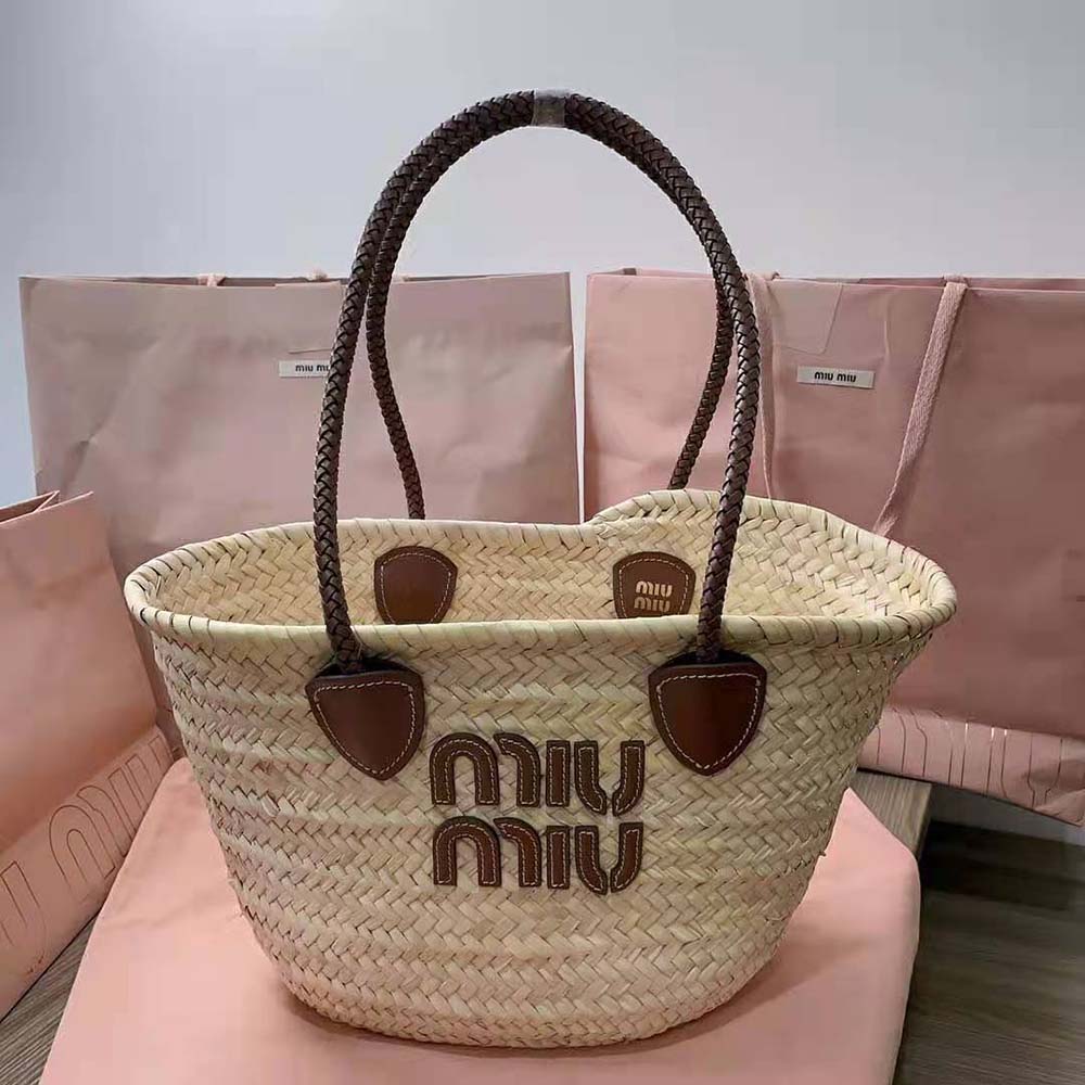 Close-up of silver hardware and embossed logo on Miu Miu tote bag