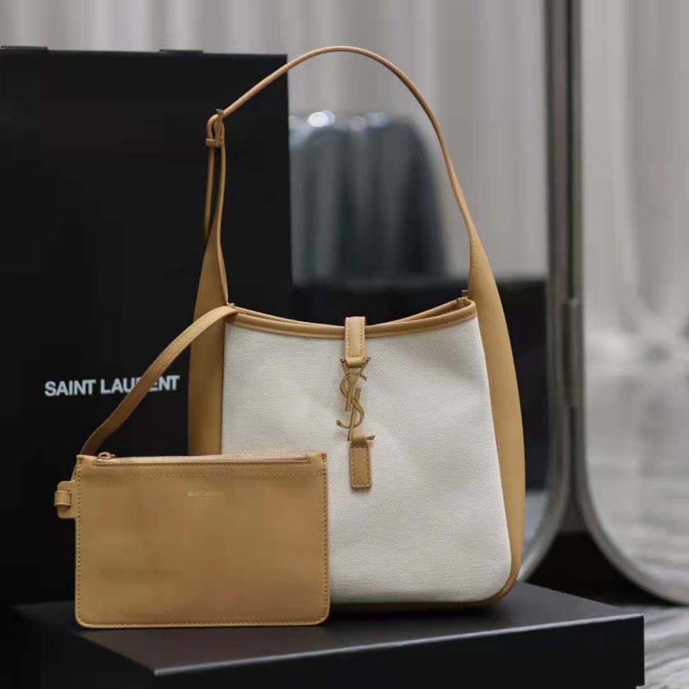 Close-up of gold YSL logo hardware on smooth leather detail