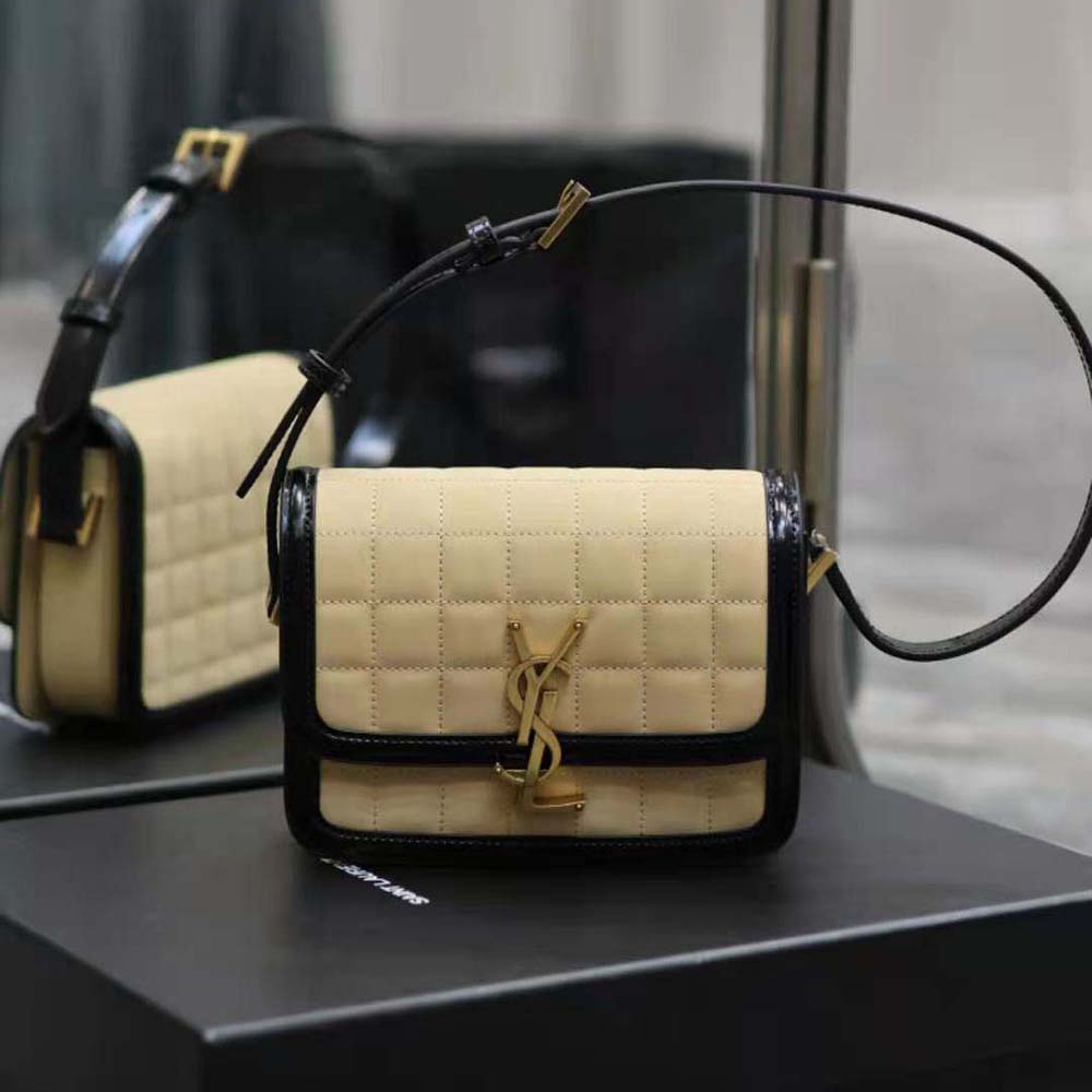 Close-up of quilted nubuck suede and gold YSL hardware detail