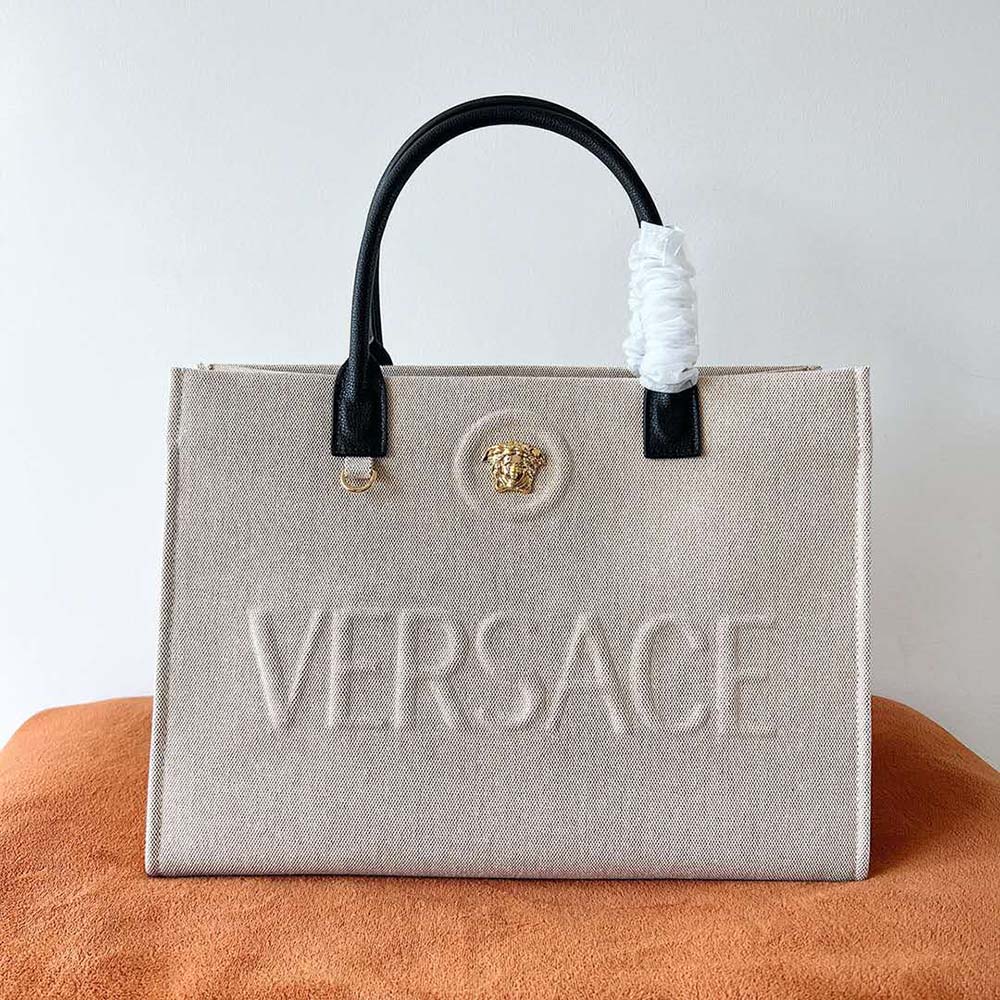 Close-up of gold Medusa hardware on Versace Women La Medusa Canvas Large Tote Bag-Beige