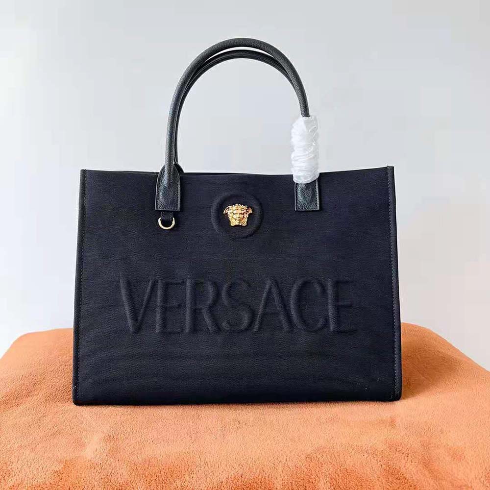 Close-up of gold-tone Medusa hardware on the Versace Women La Medusa Canvas Large Tote Bag-Black