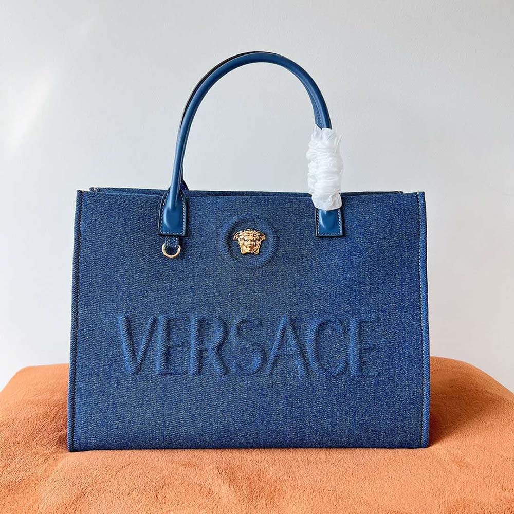 Close-up of gold Medusa hardware on Versace Women La Medusa Denim Large Tote Bag-Blue