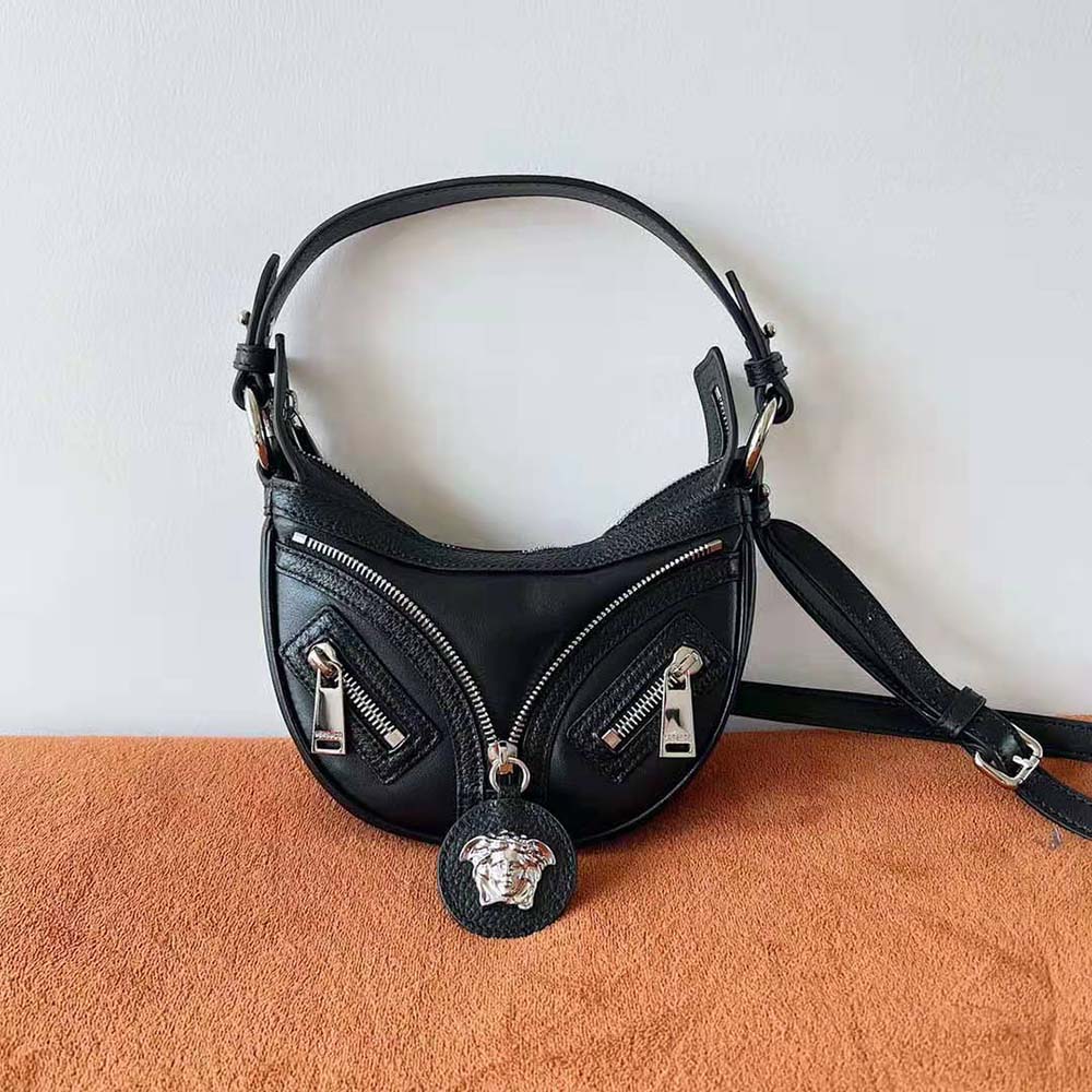 Detail of gold-tone hardware on Versace Women Repeat Mini Hobo Bag-Black