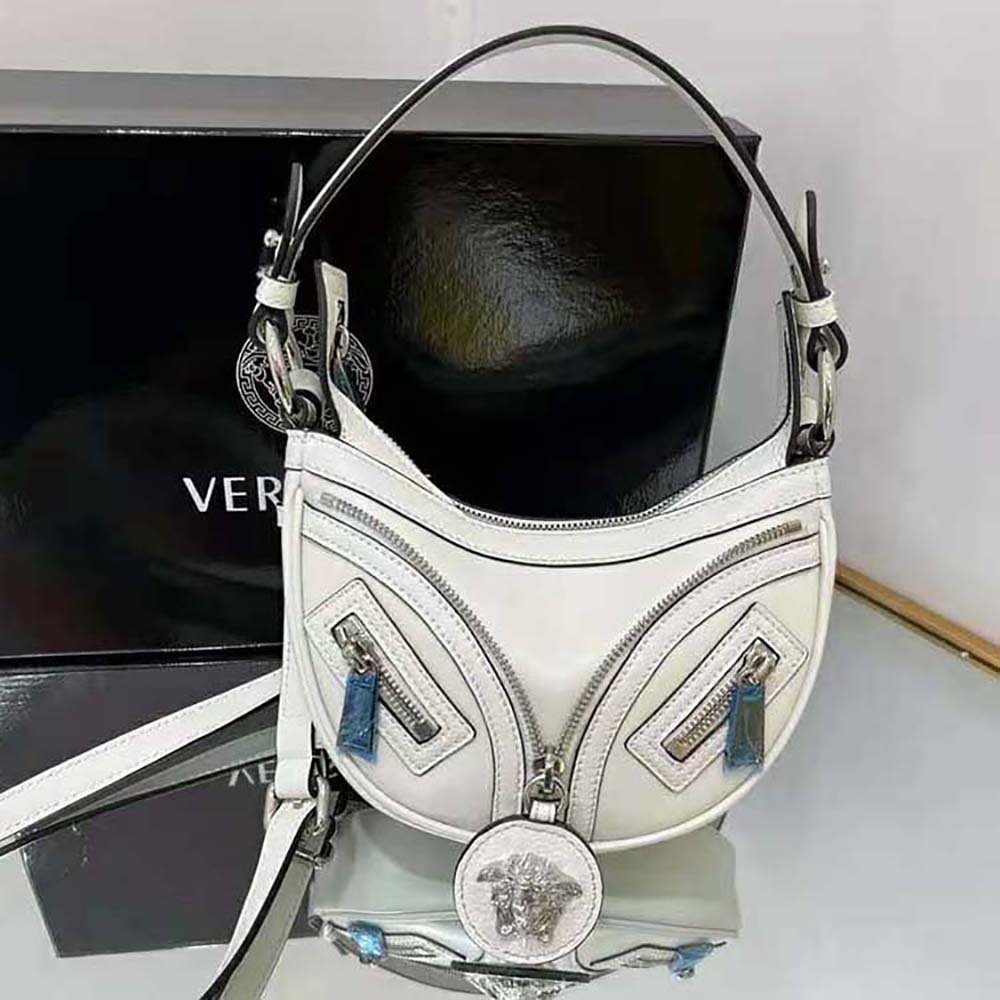 Side view showcasing silhouette and adjustable strap of Versace Women Repeat Mini Hobo Bag-White
