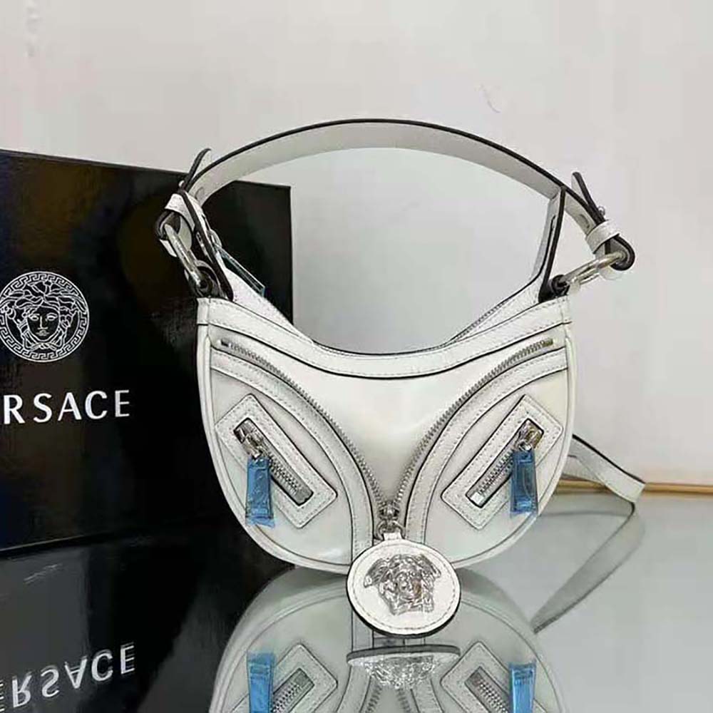 Close-up of embossed logo and leather texture on Versace Women Repeat Mini Hobo Bag-White