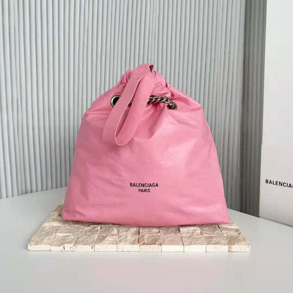 Close-up of pink crushed calfskin texture and gunmetal hardware on tote
