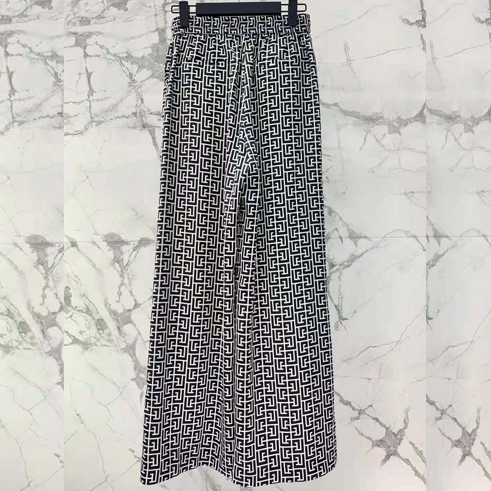 Side angle showing flowing silhouette of Balmain Women Monogrammed Flowing Trousers