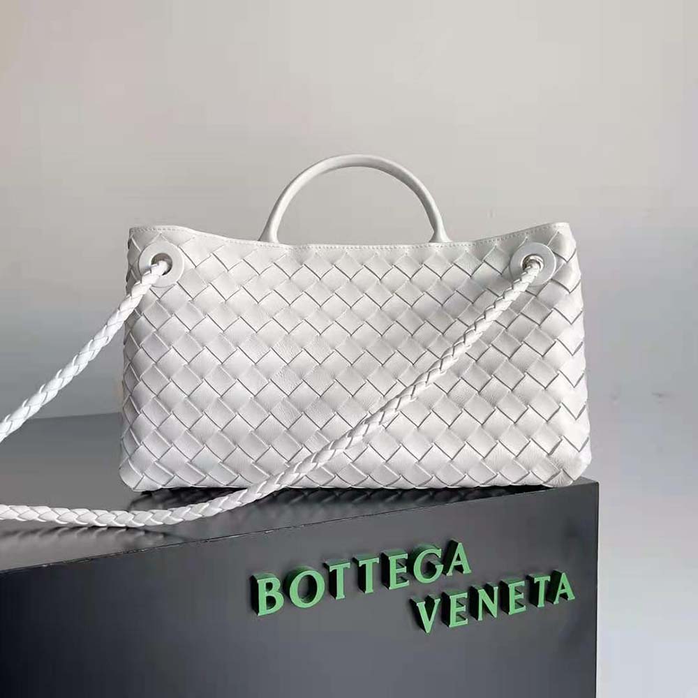 Side profile showing shoulder strap and sleek silhouette of Andiamo-White bag