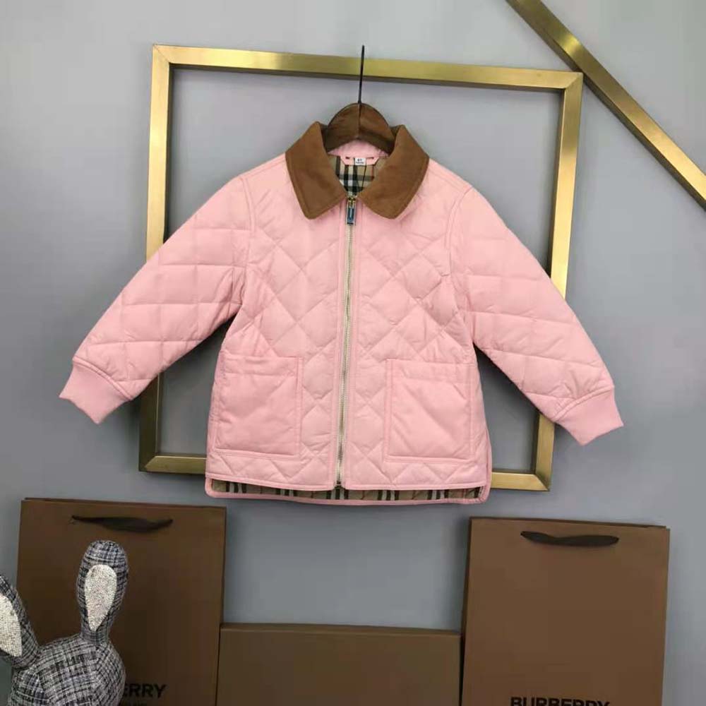 Close-up on corduroy collar and diamond quilt detailing on the jacket