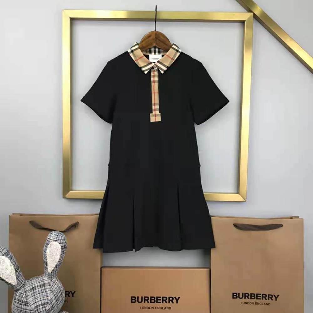 Close-up of Burberry vintage check trim on black polo shirt dress collar