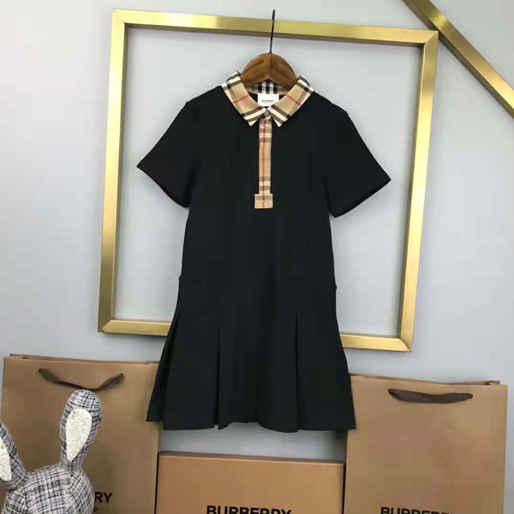 Side angle showing silhouette and button closure of Burberry polo shirt dress