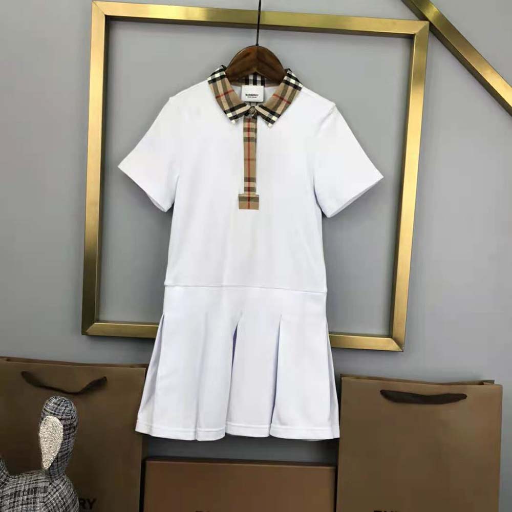 Side angle showing silhouette of Burberry Girls’ Vintage Check Trim Cotton Piqué Polo Shirt Dress-White