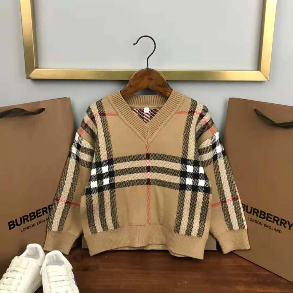Close-up detail of Burberry check and wool texture on kids’ sweater