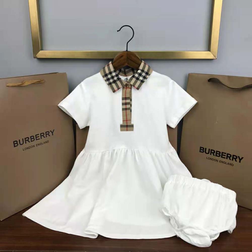 Close-up of signature Burberry check trim on dress sleeves detail