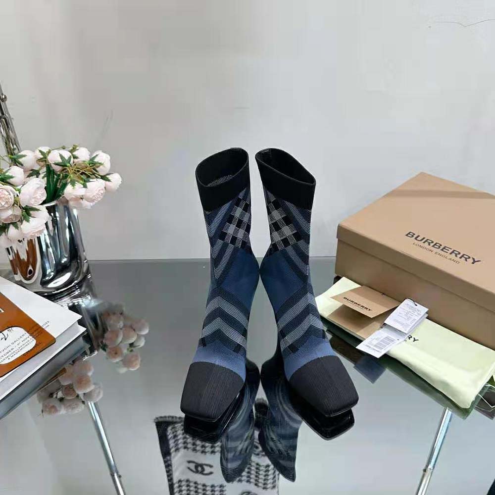 Close-up of Burberry Check detail on knit fabric sock boots navy