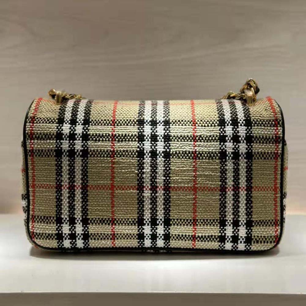 Side profile showing Burberry check interior of Medium Lola Bag