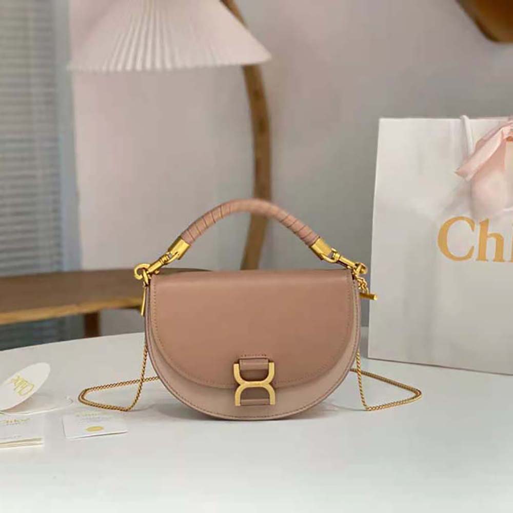 Close-up of antique gold chain and sandy leather on Chloé Marcie Bag