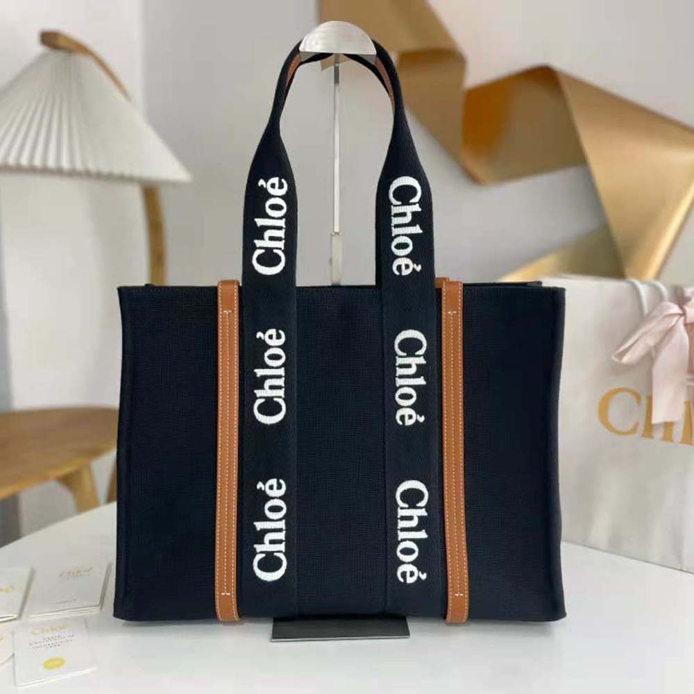 Close-up of woody handle and gold-tone closure on Chloe Women Medium Woody Tote Bag-Black