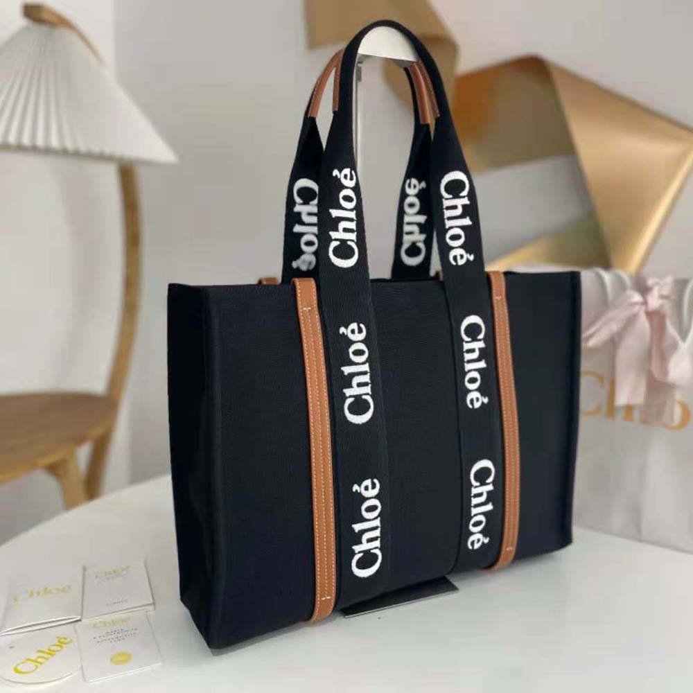 Side angle highlighting silhouette of Chloe Women Medium Woody Tote Bag-Black