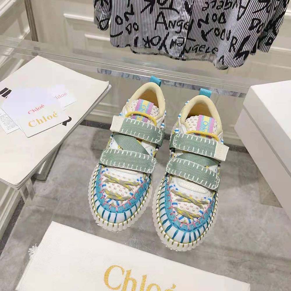 Close-up of gold-tone Chloé logo on blue slip-on sneaker