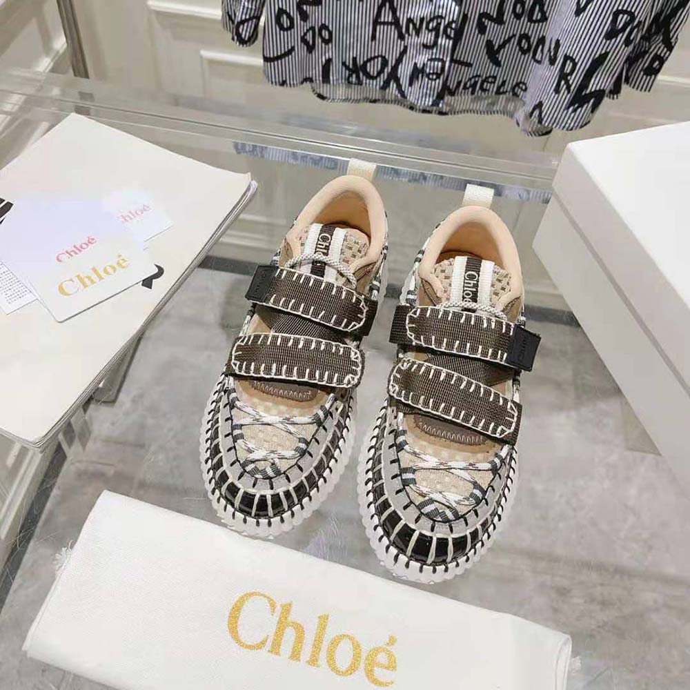 Close-up of brown leather and gold logo detail on Chloe Women Nama Sneaker