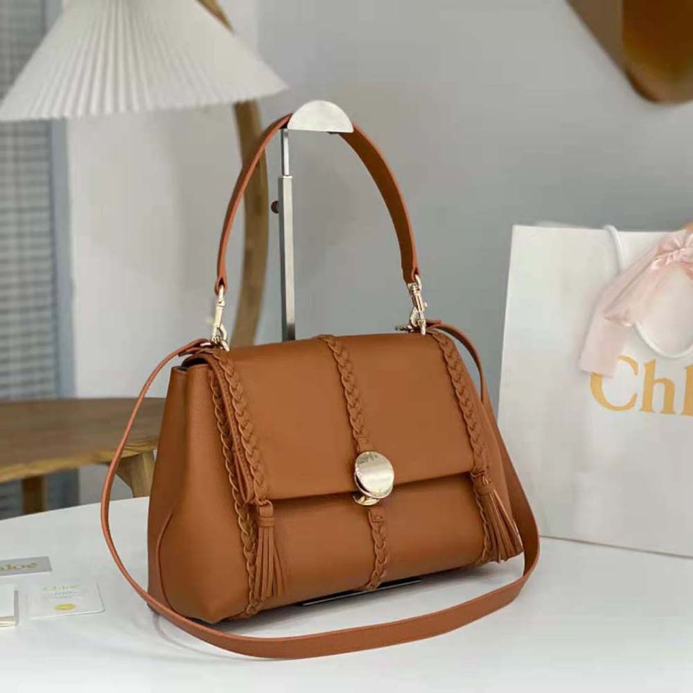 Side angle of Chloe Women Penelope Medium Soft Shoulder Bag-Brown displaying silhouette