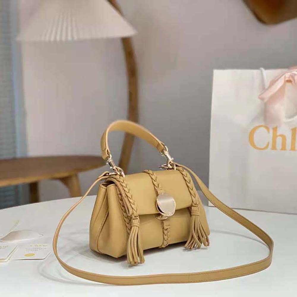 Side angle showing soft leather texture of Chloé Penelope Mini Soft Shoulder Bag-Brown