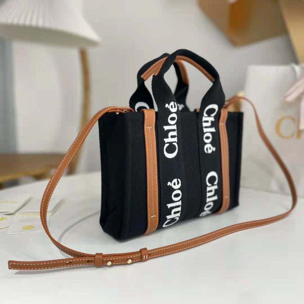 Side angle of Chloe Women Small Woody Tote Bag-Black displaying compact silhouette